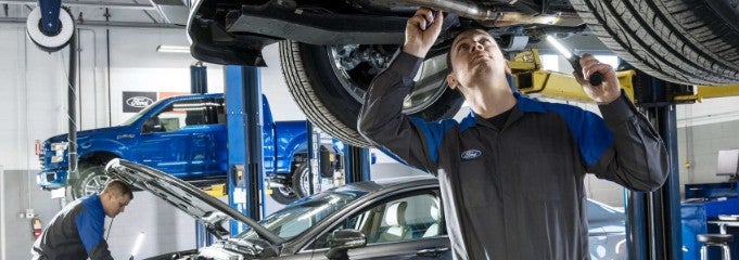 Technician inspecting a vehicle